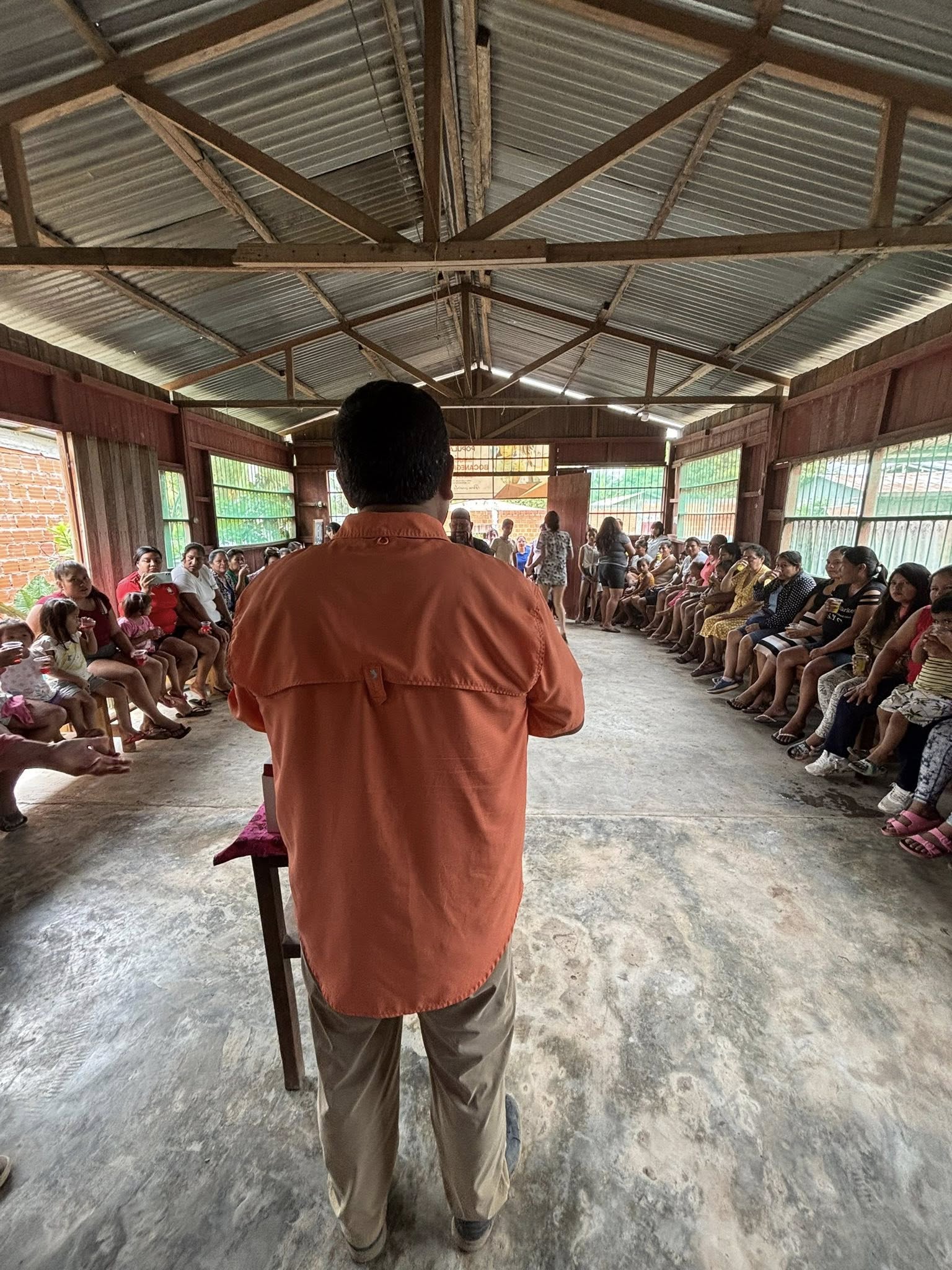 Juan addressing people in the community.