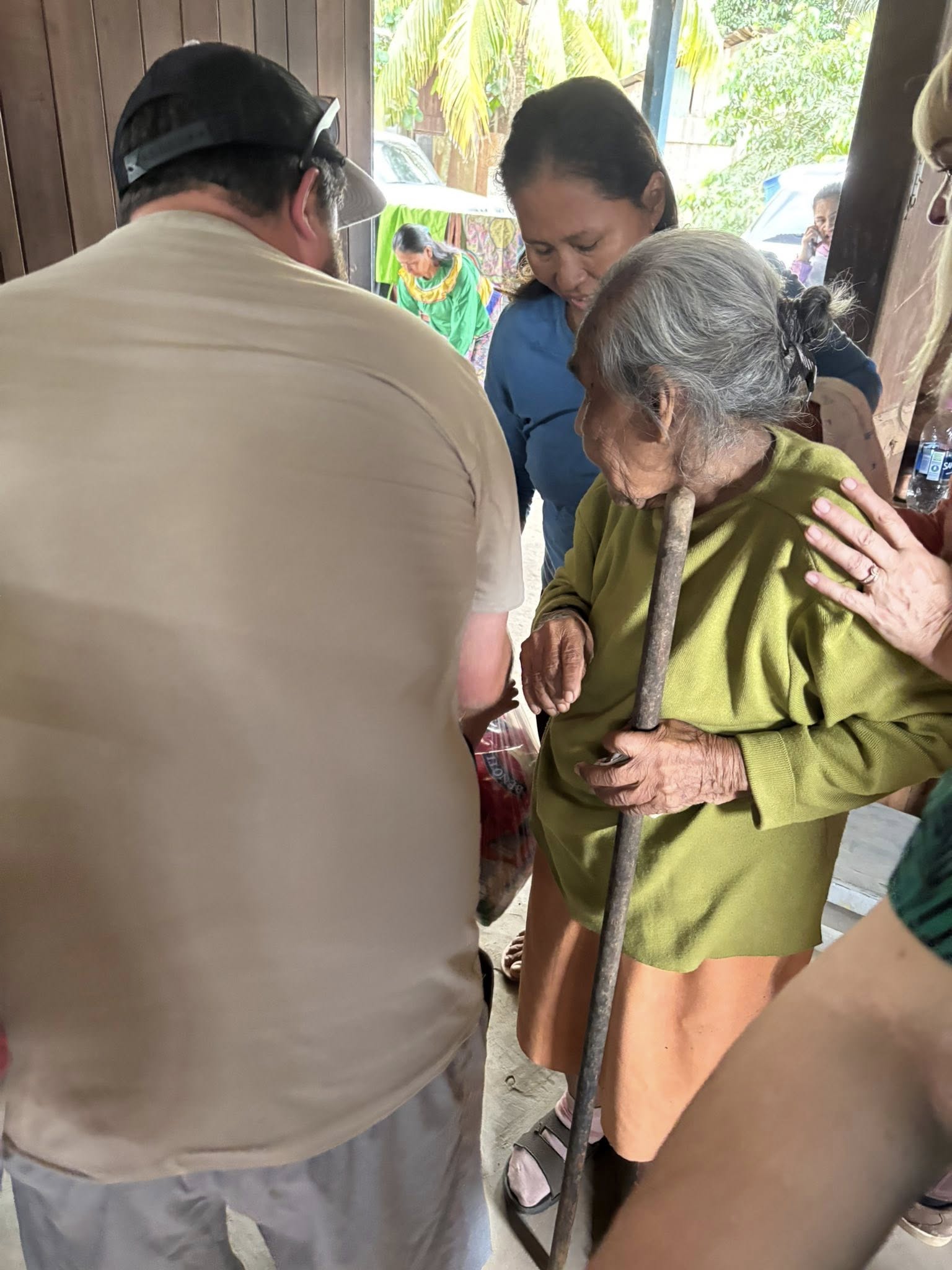 Helping an elderly lady find a seat.