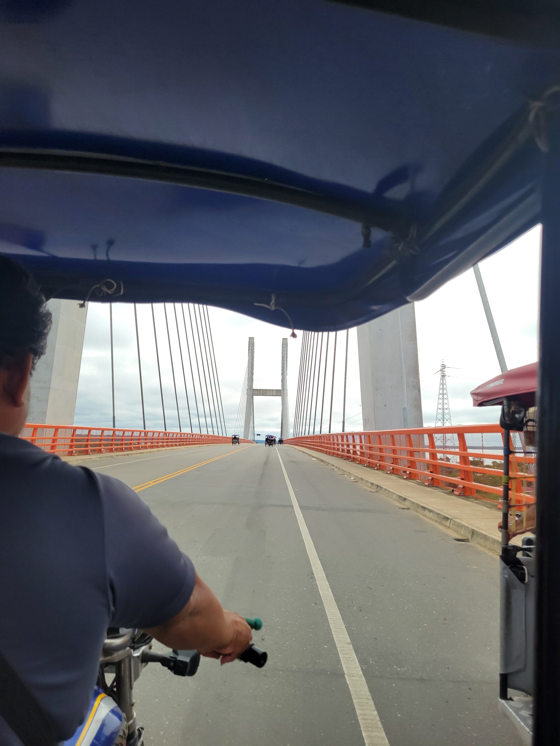 Riding in a Motokar to the bridge.