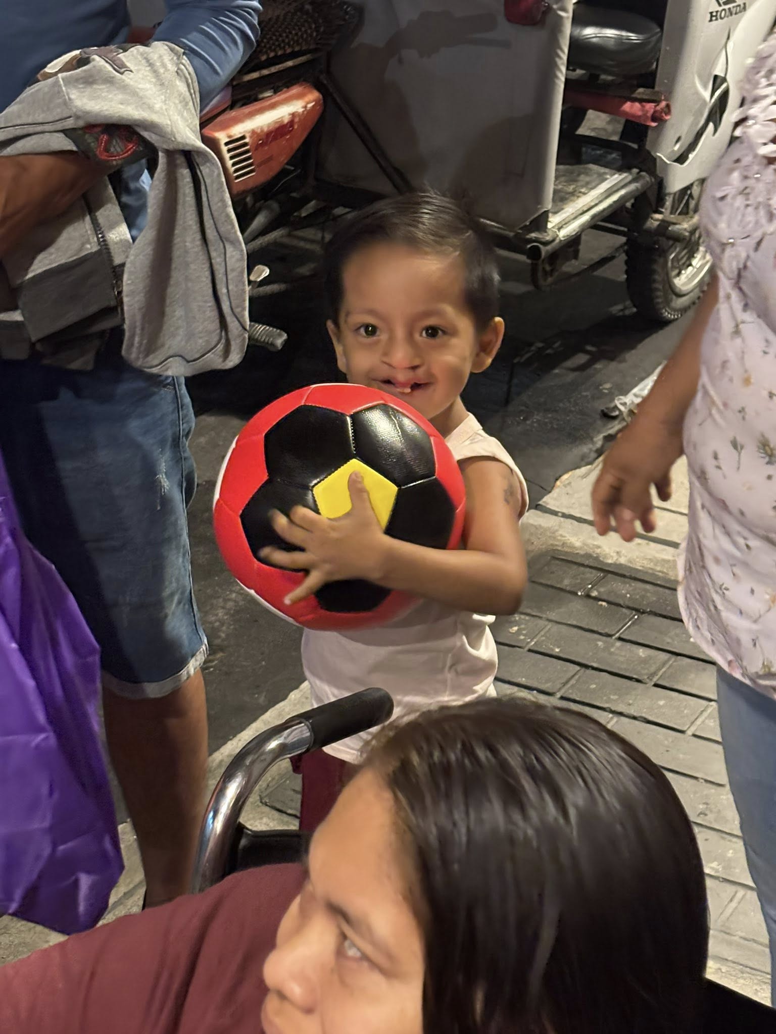 Dariel with his new ball. Look at that smile.