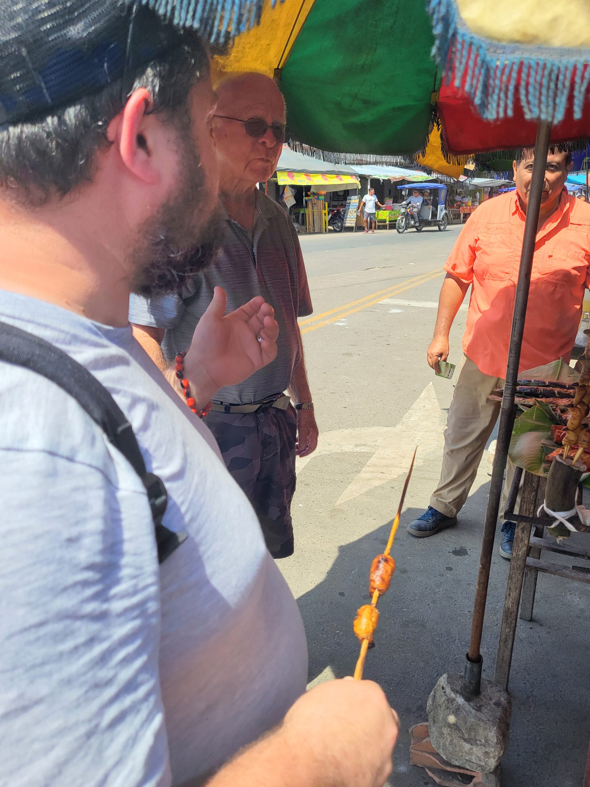 Shaun eating cooked grubworms.