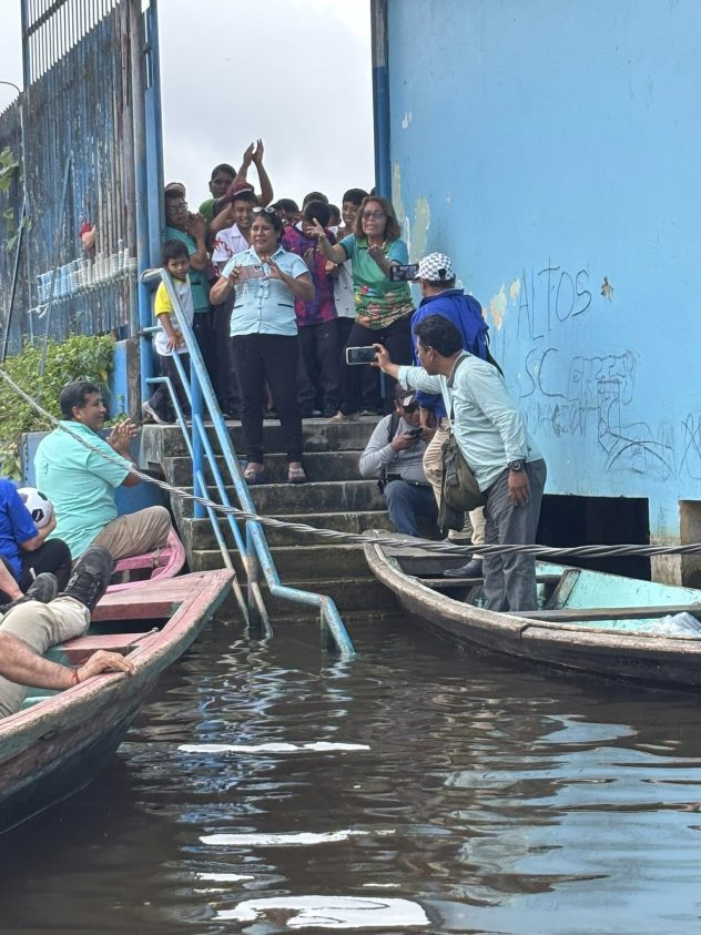 Giving two soccer balls to the children at a school.