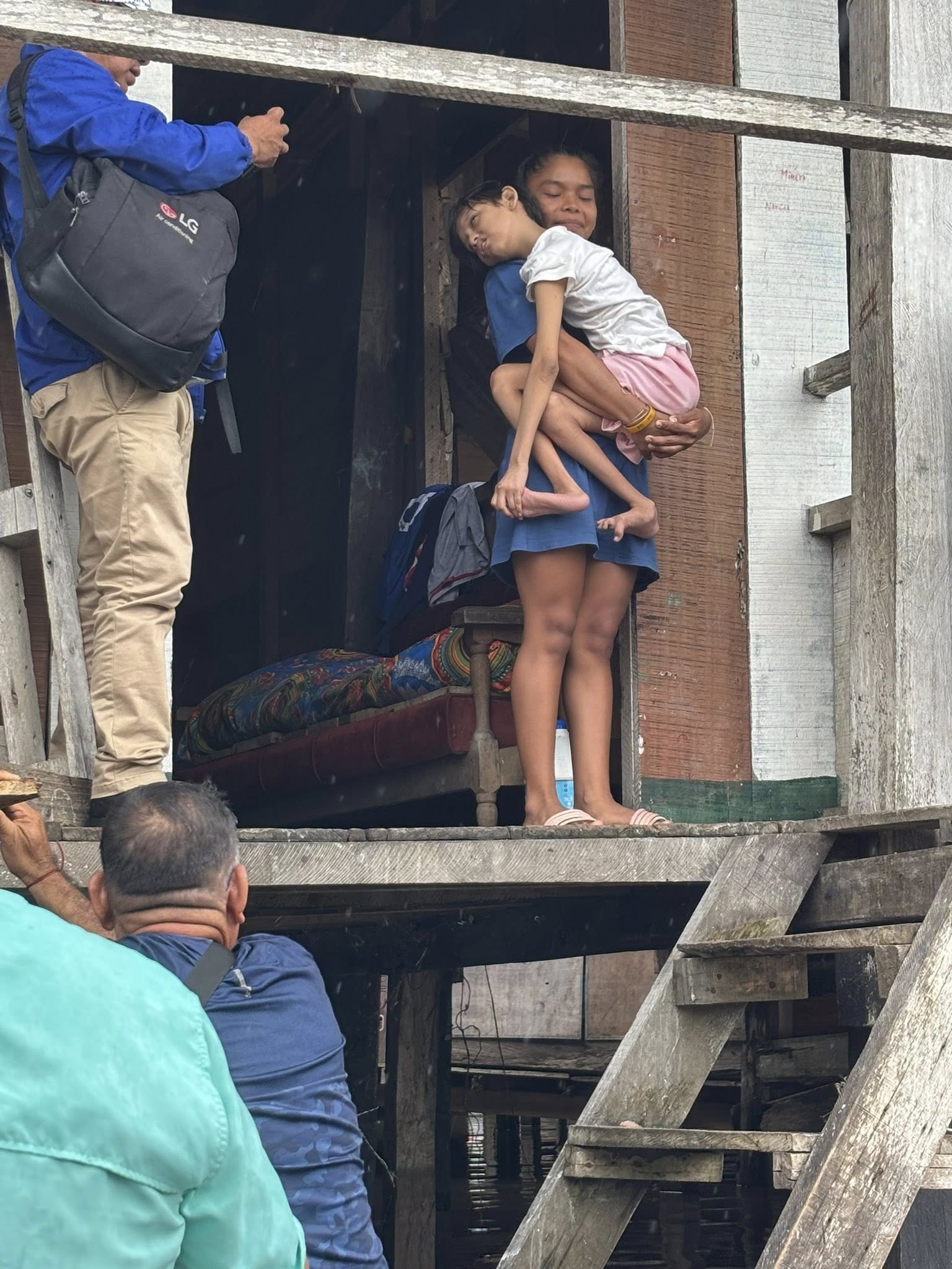 Ashley living with a disability and her big sister caring for her.